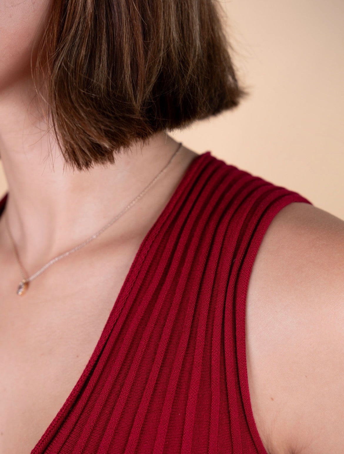 Sleeveless fit and flare knit dress with V-neckline and flowing pleats – The Alba Dress by Iris & Loom