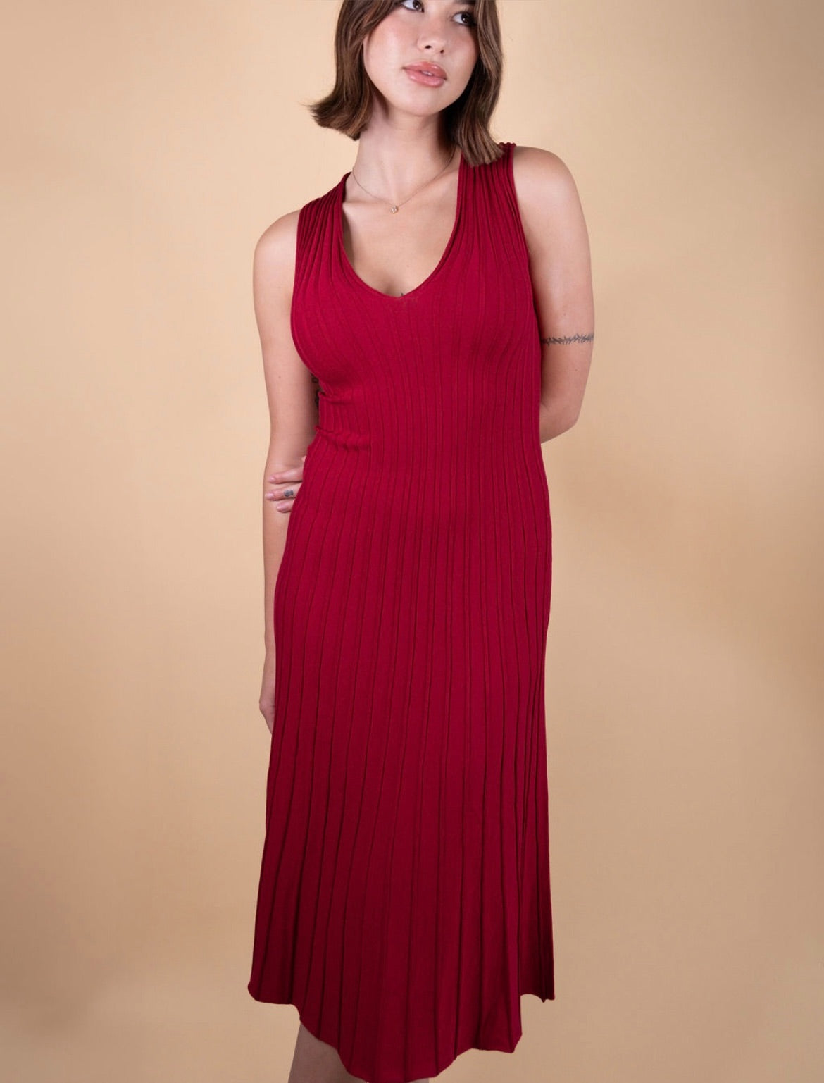 Sleeveless fit and flare knit dress with V-neckline and flowing pleats – The Alba Dress by Iris & Loom